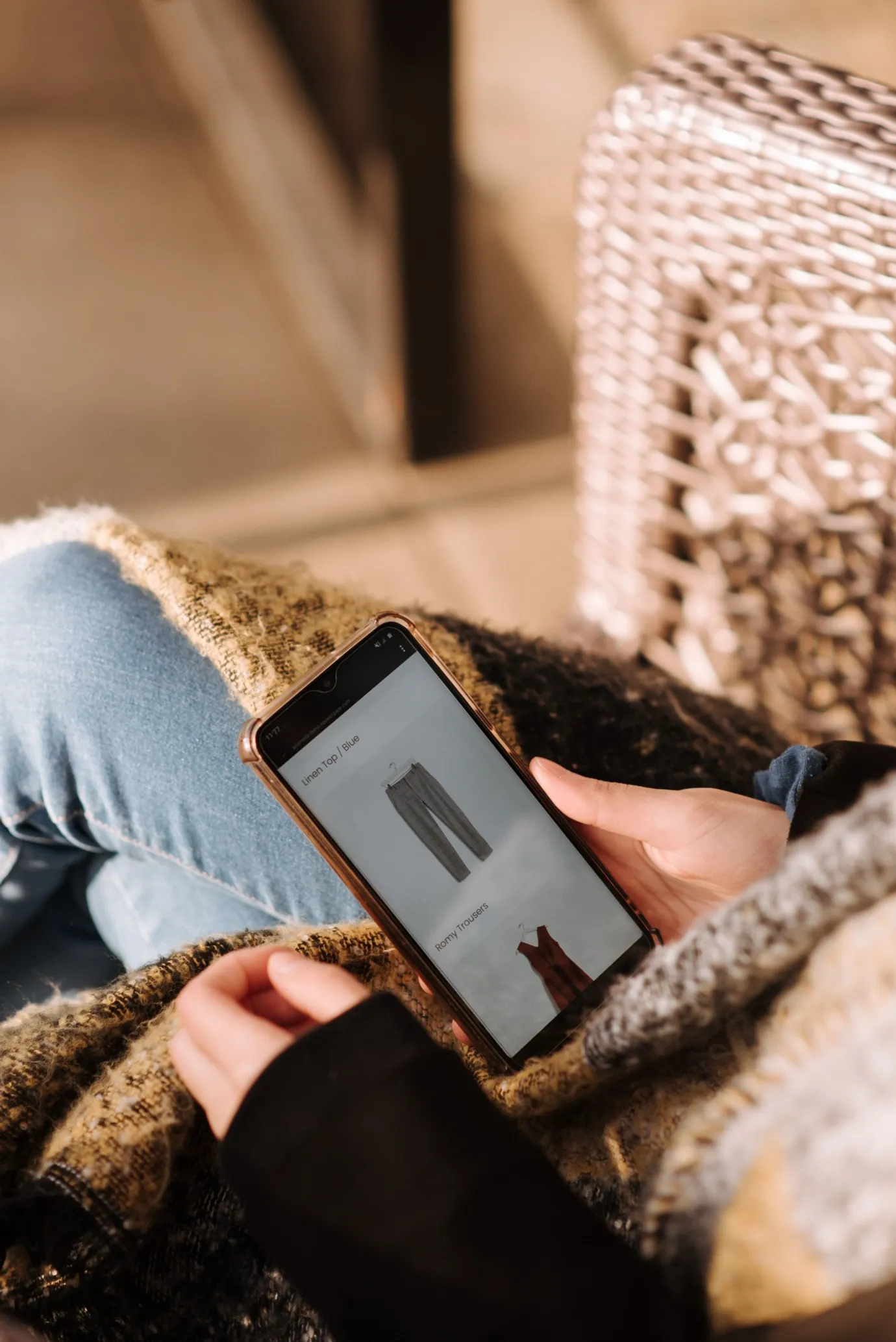 Shopper browsing a fashion store's product page on a phone