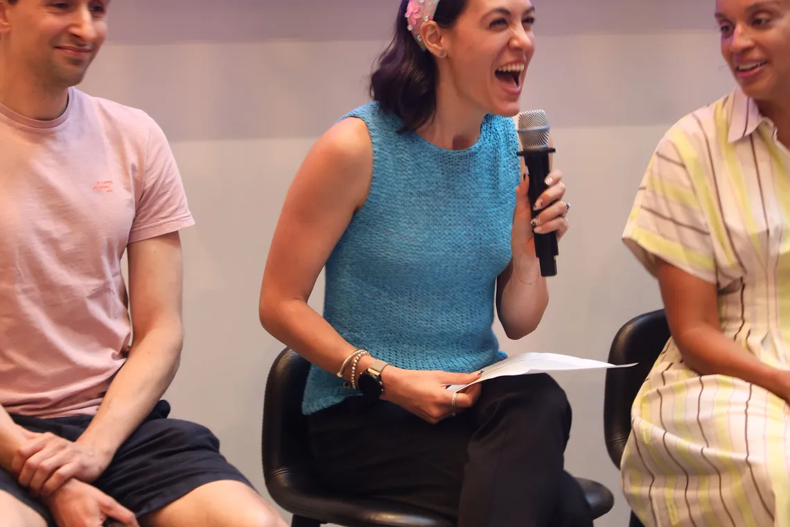 Panelists seated on stage during an animated moment of the discussion